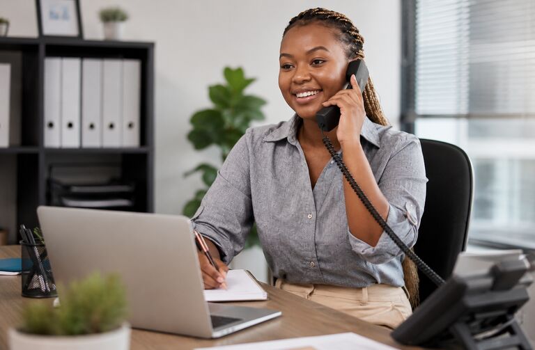 A support professional taking a client call at her desk
